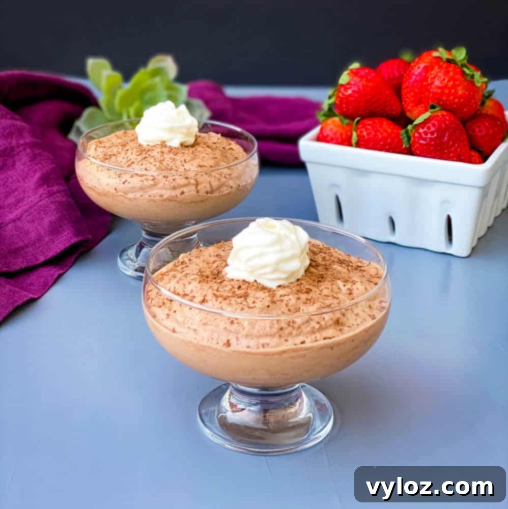 Effortless Sugar-Free Chocolate Mousse 2 Keto Low Carb Chocolate Mousse served in a elegant glass bowl with a side of fresh, vibrant strawberries