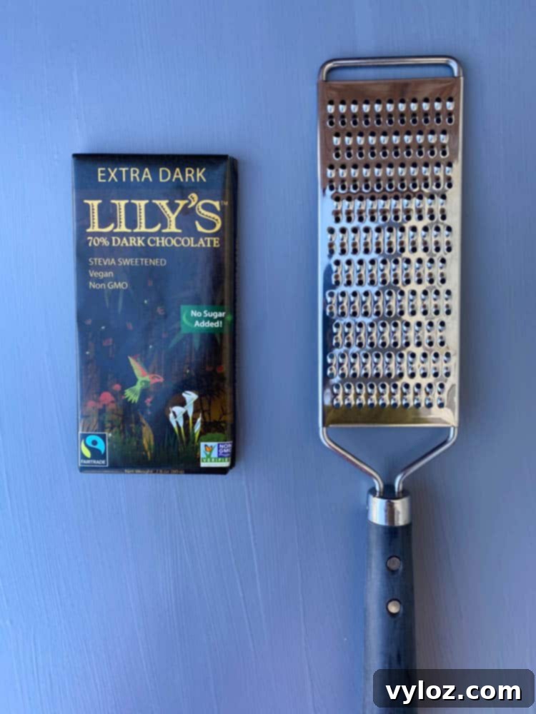 Effortless Sugar-Free Chocolate Mousse 10 A wrapped sugar-free chocolate bar and a cheese grater, illustrating how to make chocolate sprinkles for garnish