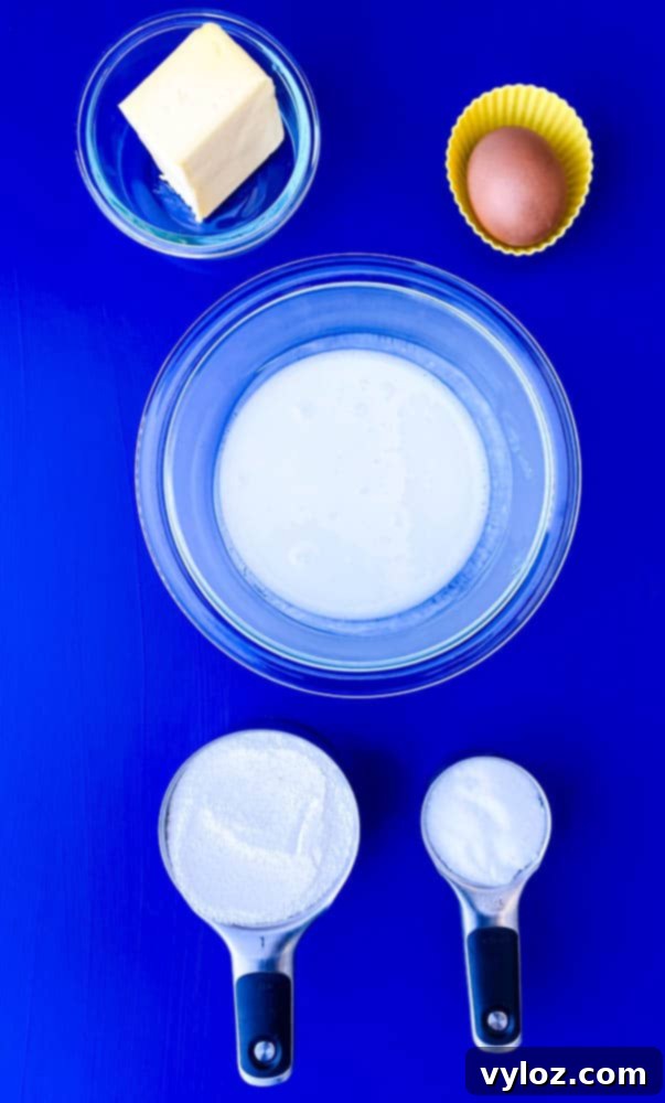 Crispy Air Fryer Cornbread 3 Selection of fresh ingredients: butter, buttermilk, yellow cornmeal, sweetener, and an egg, ready for making air fryer cornbread.