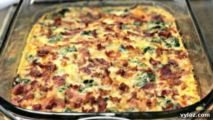 A hearty low-carb bacon, egg, and spinach breakfast casserole with cheese, mushrooms, and peppers, perfect for meal prep.