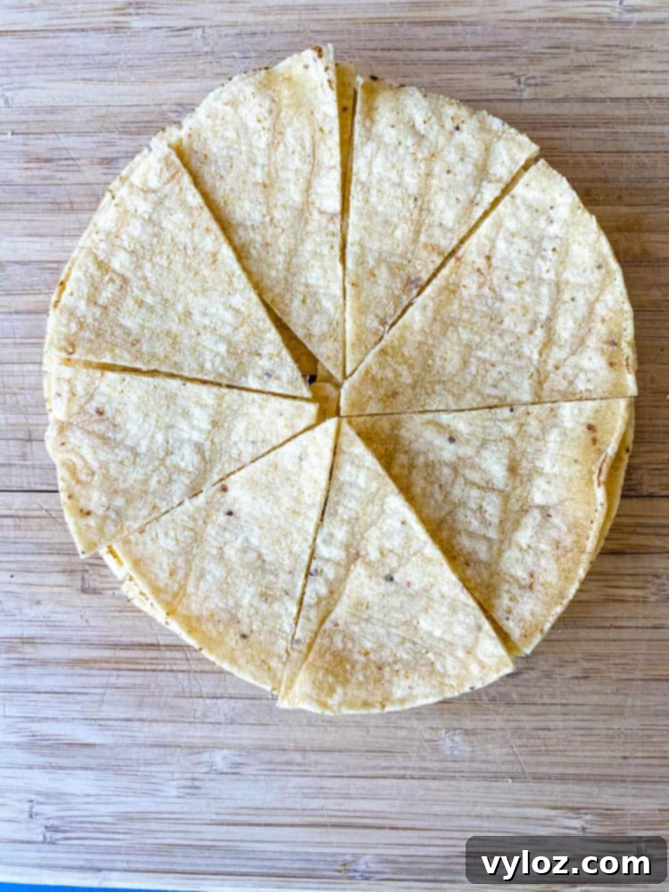 sliced corn tortillas on a cutting board for air fryer tortilla chips