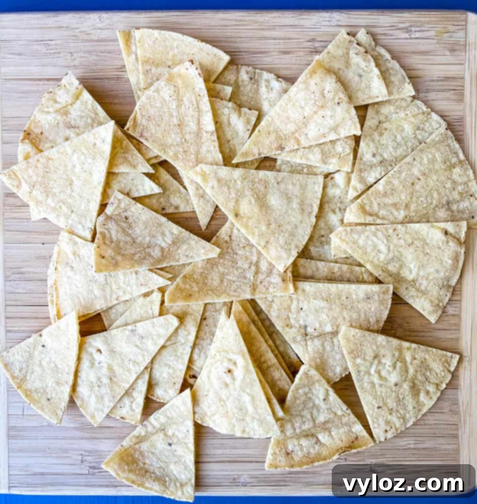 sliced corn tortillas on a cutting board for air fryer tortilla chips