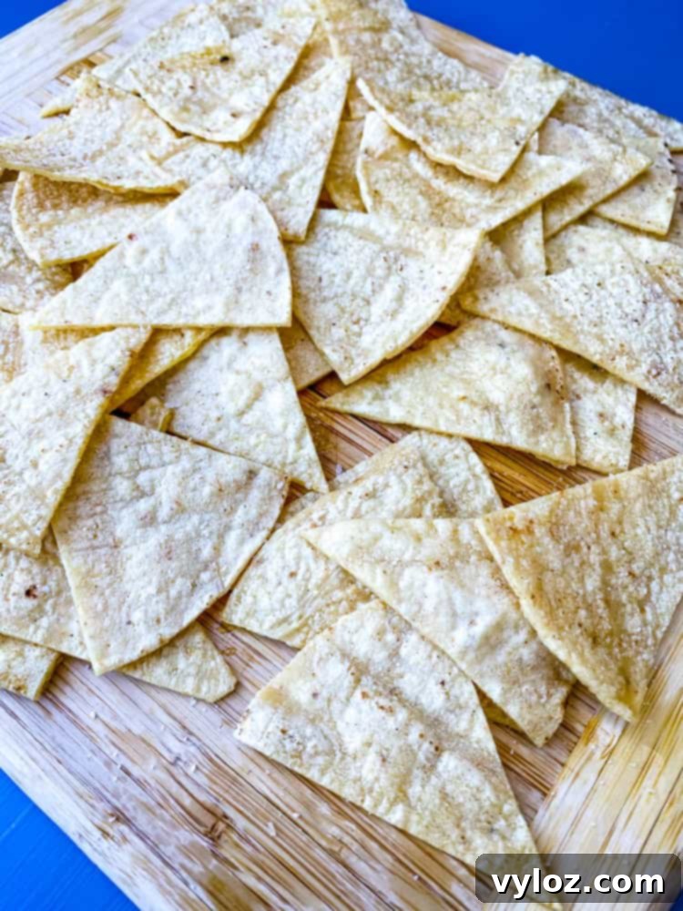 sliced corn tortillas on a cutting board for air fryer tortilla chips