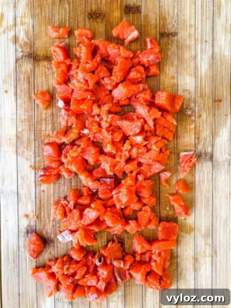 wild caught salmon diced on a cutting board