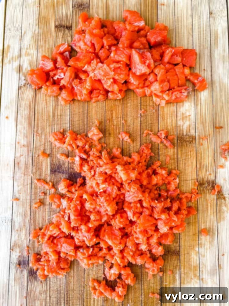 diced and minced salmon on a cutting board