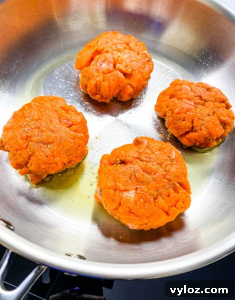 keto low carb salmon patties in a stainless steel frying pan