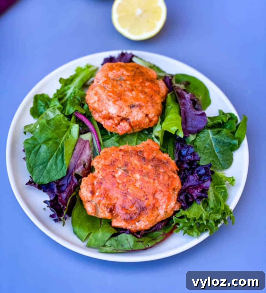 keto low carb salmon patties on a plate with mixed greens