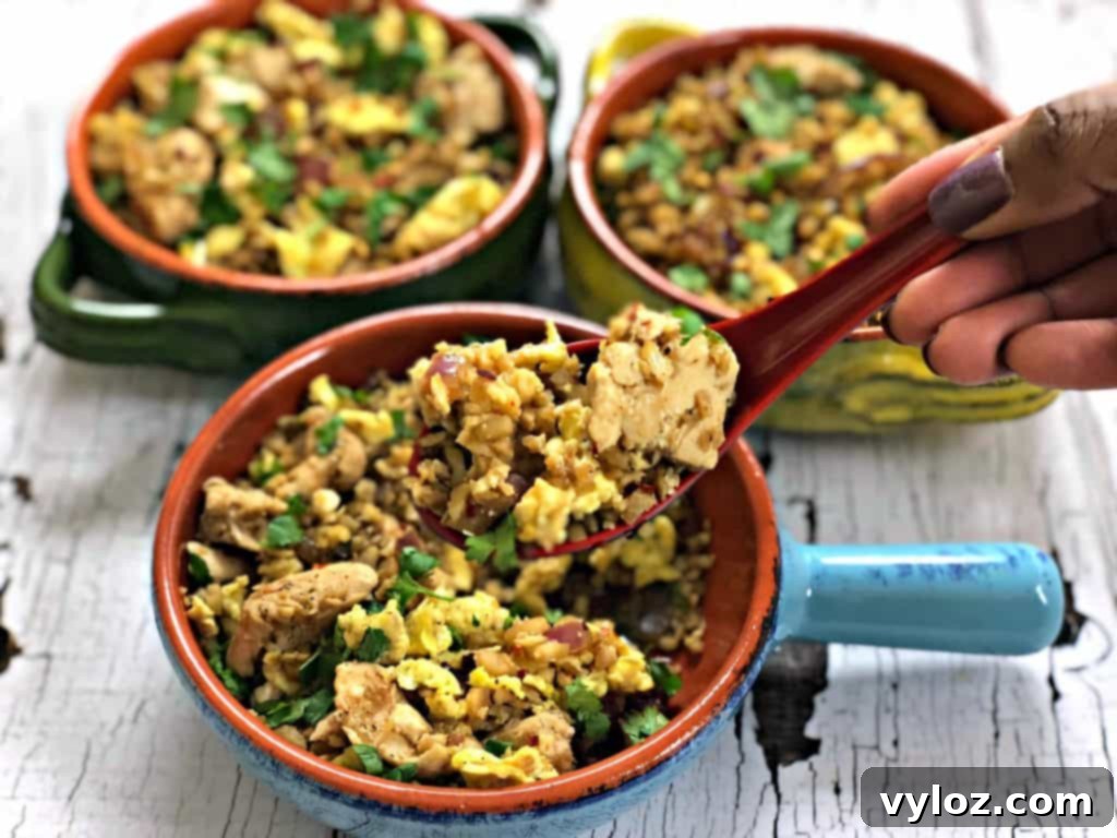 Close-up of succulent chicken pieces stir-frying in a hot pan, an essential step for preparing Keto Low-Carb Cauliflower Chicken Fried Rice