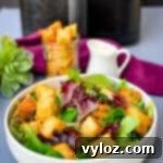 Crispy Air Fryer Croutons 11 Air fryer croutons on a salad in a white bowl, showcasing the finished product