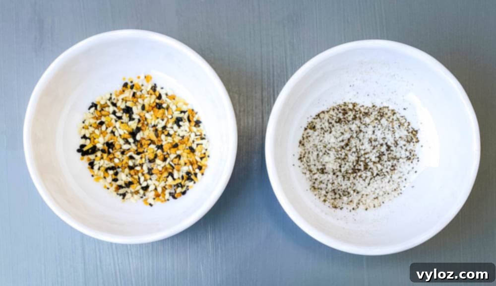 Crispy Air Fryer Croutons 3 Small white bowls holding Everything But The Bagel Seasoning, salt, and black pepper, ready for seasoning croutons