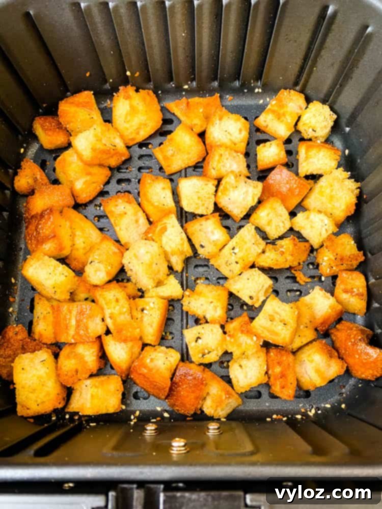 Crispy Air Fryer Croutons 8 Golden-brown sourdough croutons cooking in an air fryer basket
