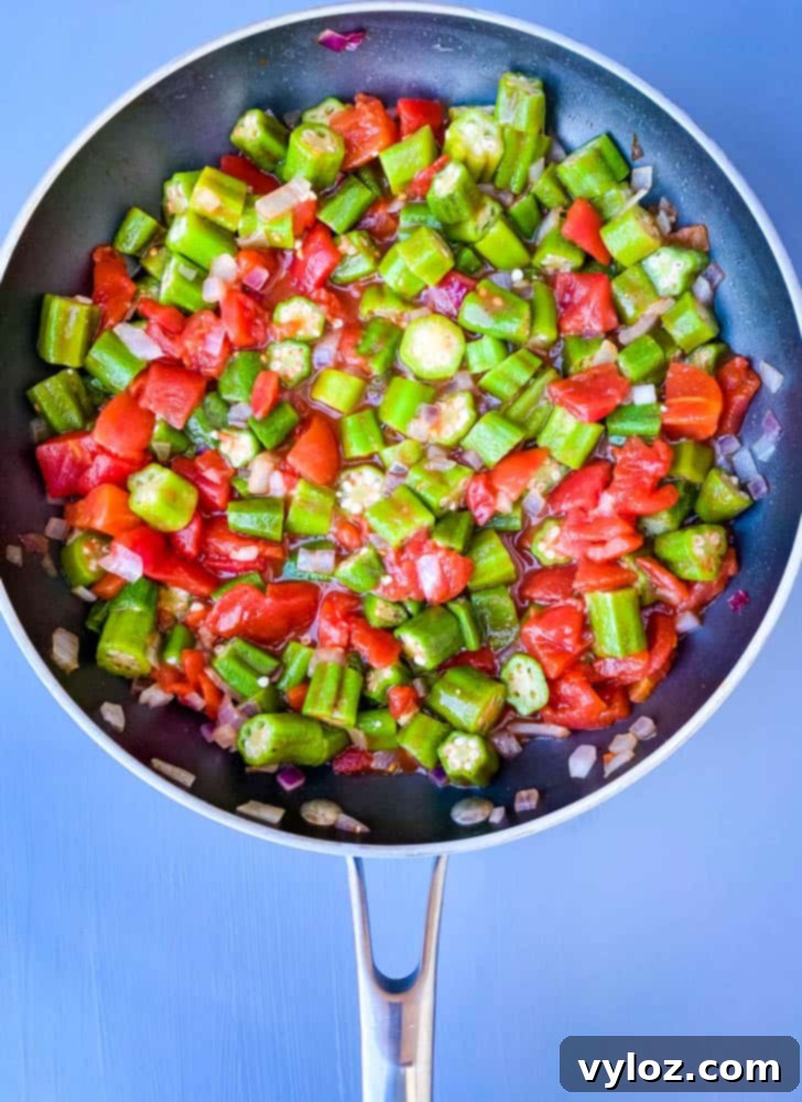 diced tomatoes and frozen okra in a skillet