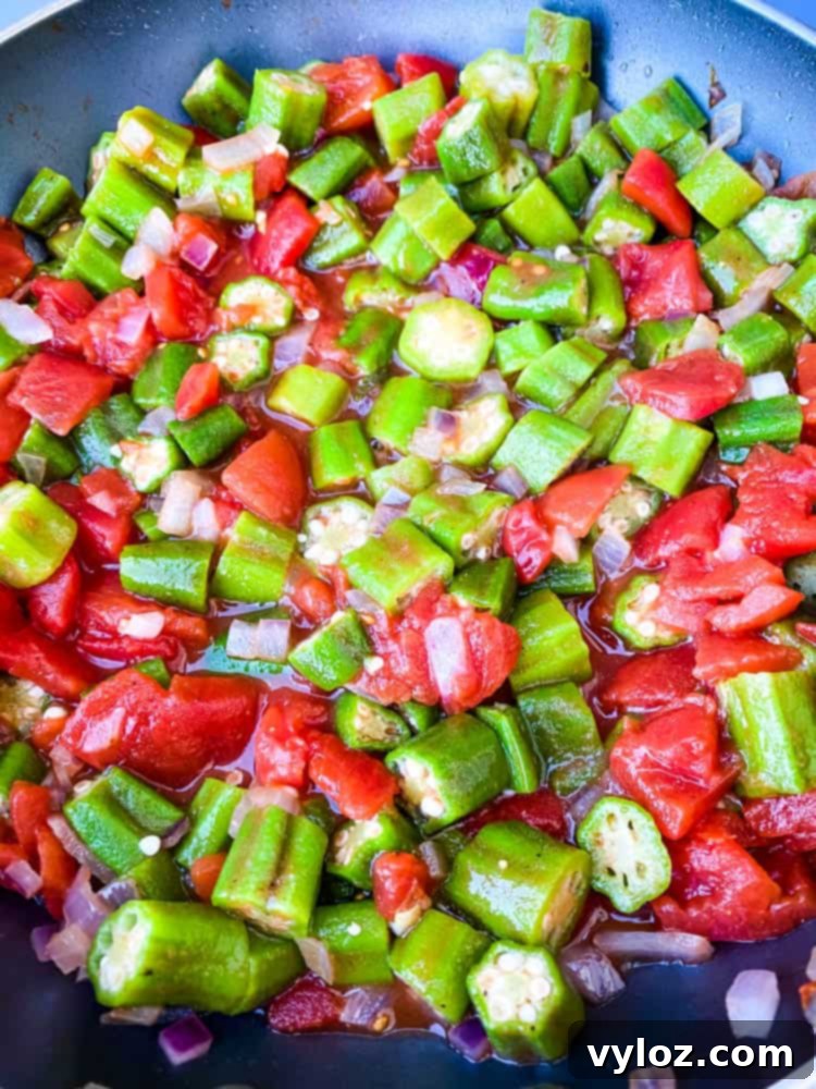 diced tomatoes and frozen okra in a skillet
