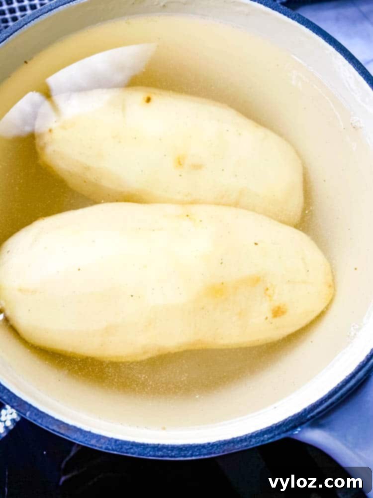 Potatoes boiling in a saucepan on a stove