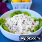 Effortless Keto Chicken Salad 11 keto chicken salad on a bed of lettuce in a white bowl