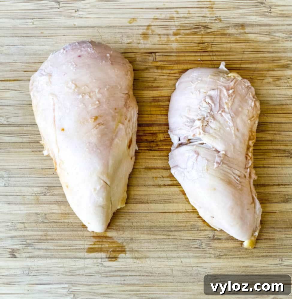 Effortless Keto Chicken Salad 5 cooked chicken breasts on a bamboo cutting board