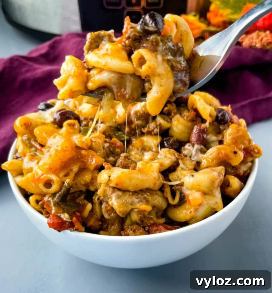 Ultimate Slow Cooker Chili Mac and Cheese 12 slow cooker chili mac and cheese in a white bowl