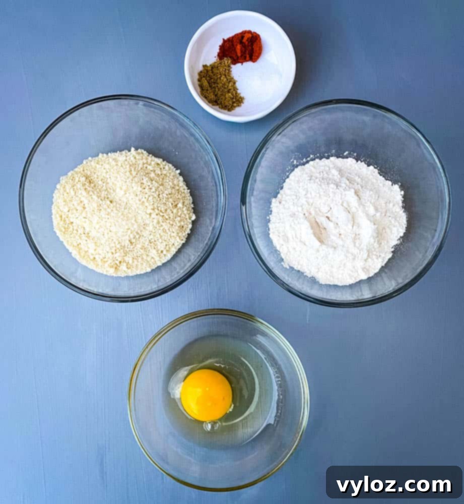 No-Fuss Air Fryer Fish 3 flour, breadcrumbs, an egg, and seasoning in separate bowls