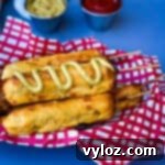 air fryer corn dogs in a basket with a red and white napkin