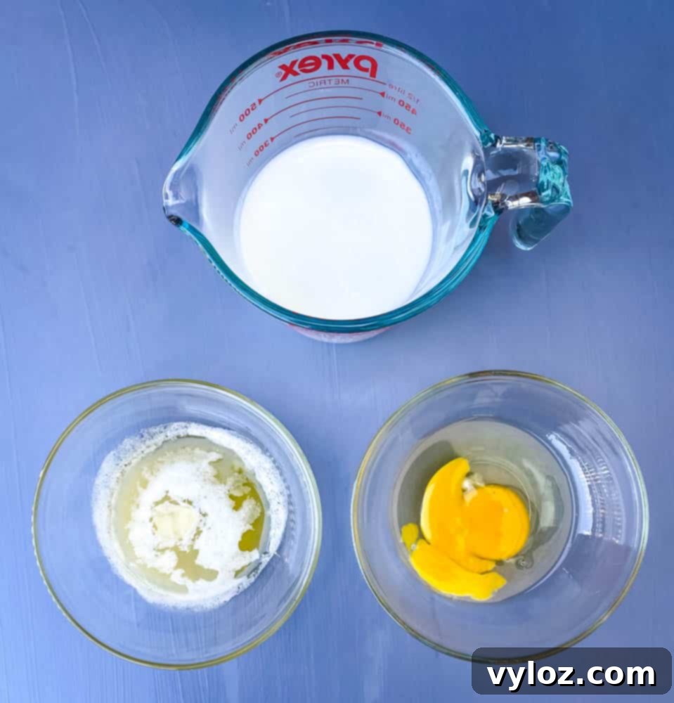 buttermilk, an egg, and melted butter in separate bowls, essential liquid ingredients for corn dog batter