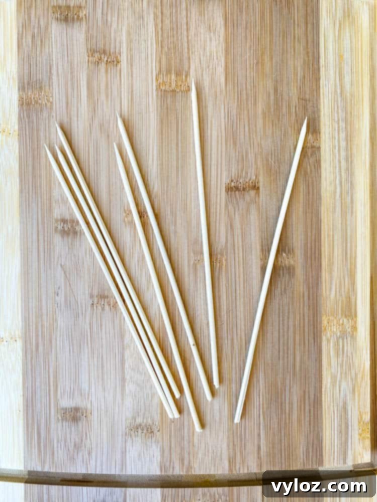 bamboo skewers on a bamboo cutting board, ready for preparing corn dogs
