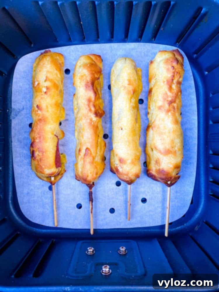 cooked corn dogs with a golden-brown and crispy finish, fresh out of the air fryer