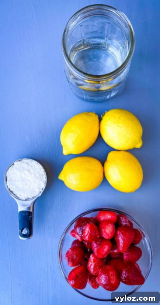 fresh lemons, fresh strawberries, water, and sweetener on a flat surface