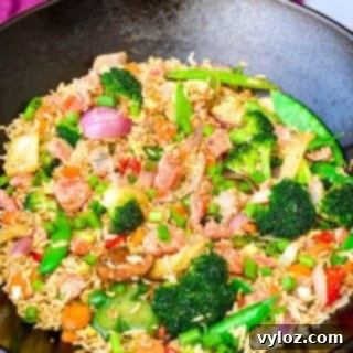 salmon fried rice with vegetables in a cast iron wok