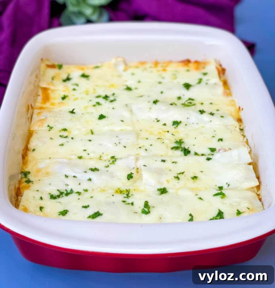 Velvety Seafood Lasagna 15 A fully baked seafood lasagna in a vibrant red baking dish, showcasing its cheesy top.