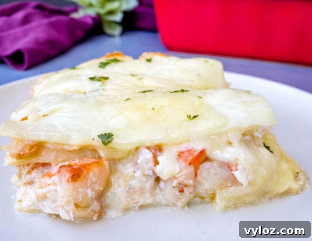 Velvety Seafood Lasagna 17 A delectable slice of seafood lasagna artfully arranged on a white plate, highlighting its rich layers and creamy texture.