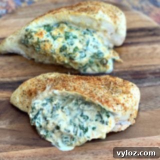 Creamy Spinach Stuffed Chicken Breast 13 Keto low carb stuffed chicken breasts on a wooden cutting board, showcasing the delicious meal.