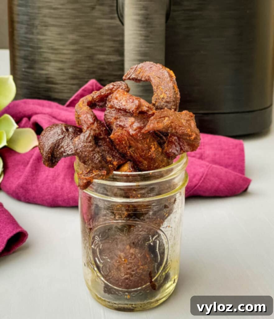 Air fryer beef jerky perfectly cooked and arranged in a glass cup