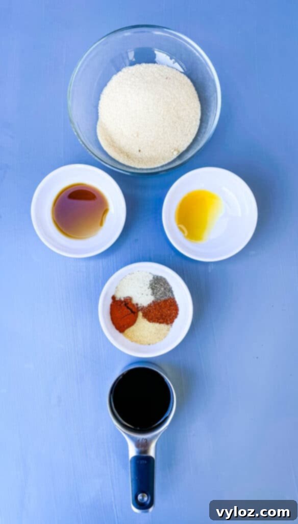 Small bowls containing key beef jerky marinade ingredients: soy sauce, liquid smoke, and worcestershire sauce