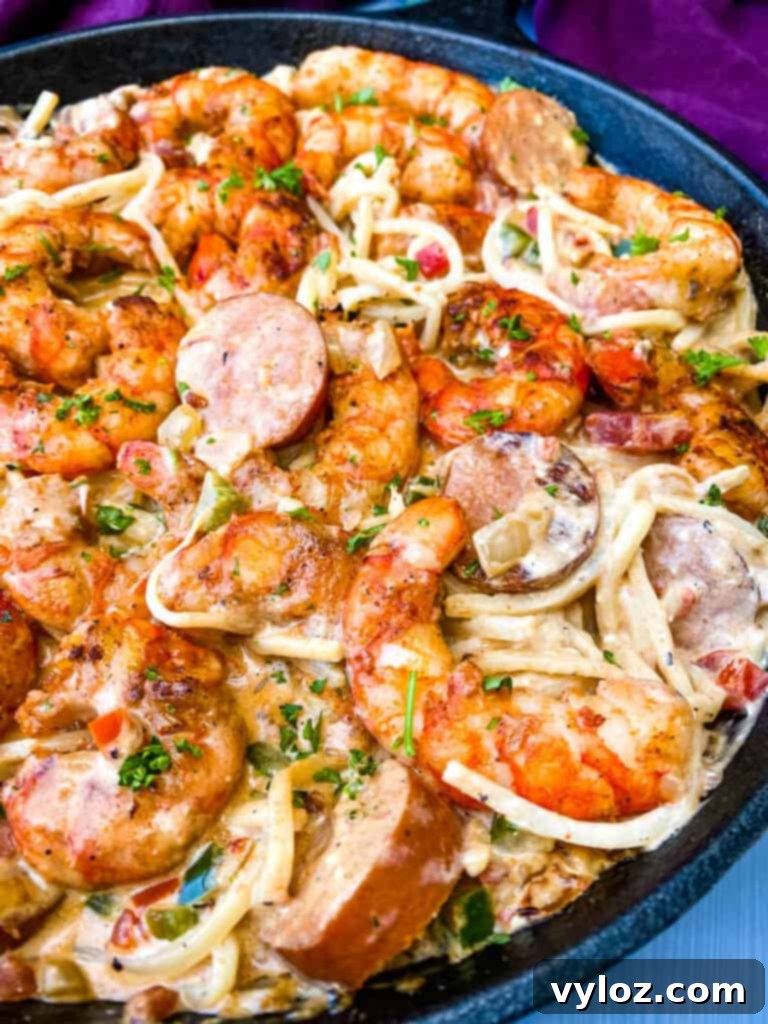 Overhead shot of Cajun shrimp pasta with low carb Palmini linguine in a cast iron skillet, ready to serve