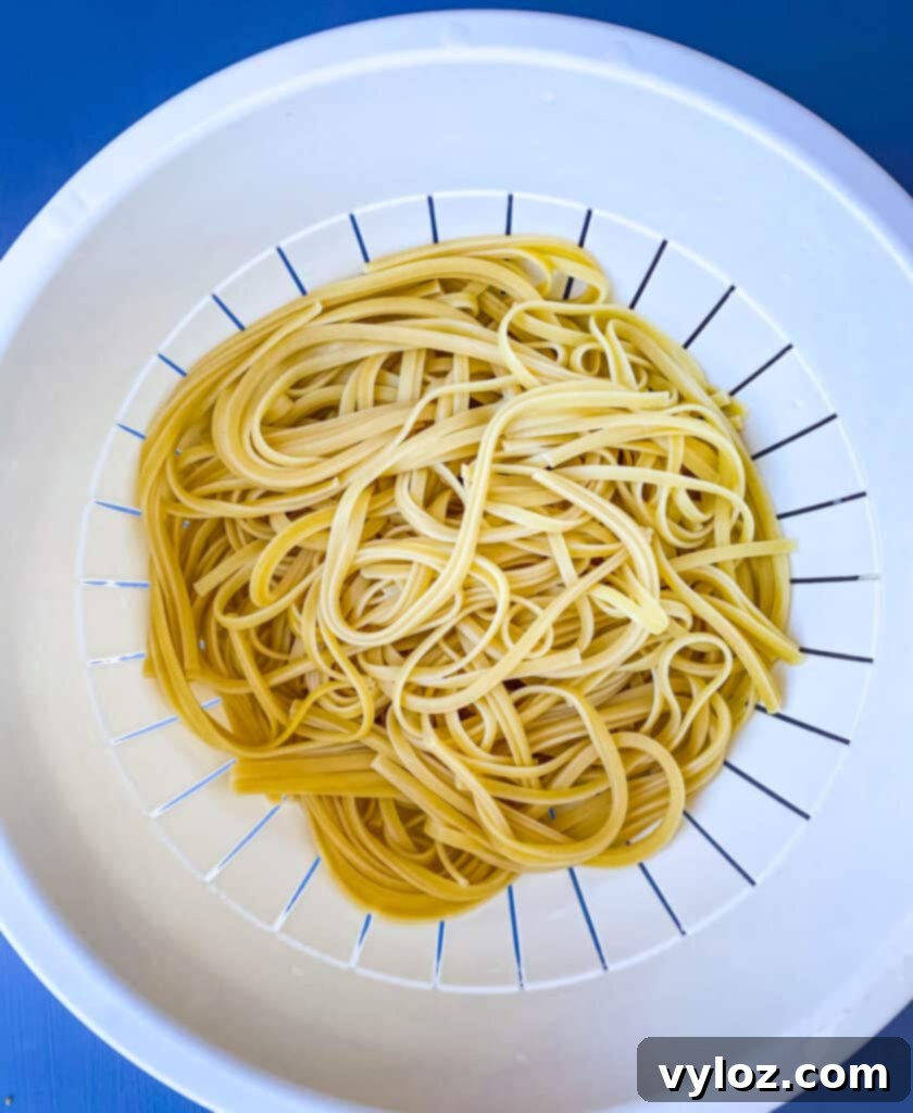 Freshly cooked linguine pasta draining in a colander