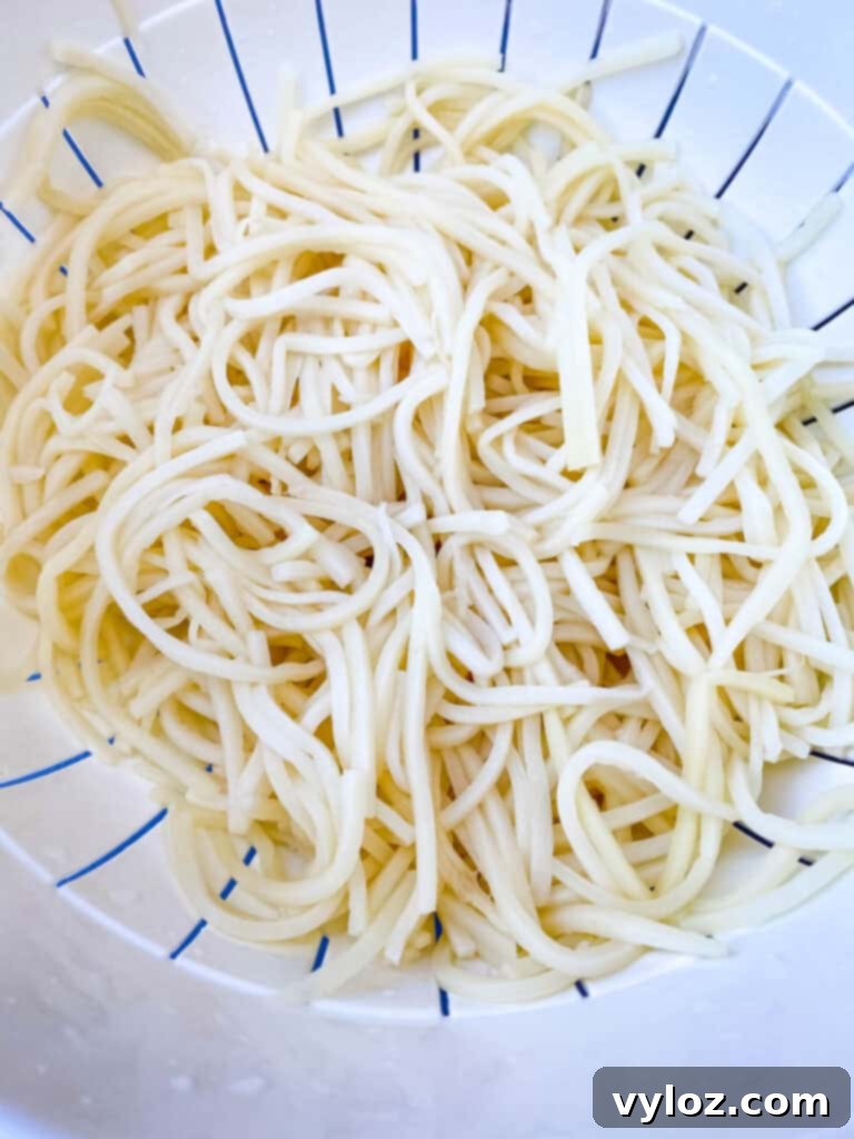 Rinsed Palmini hearts of palm linguine in a colander, prepared for cooking