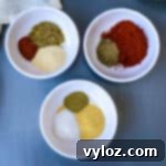spices for blackened seasoning in 3 individual bowls