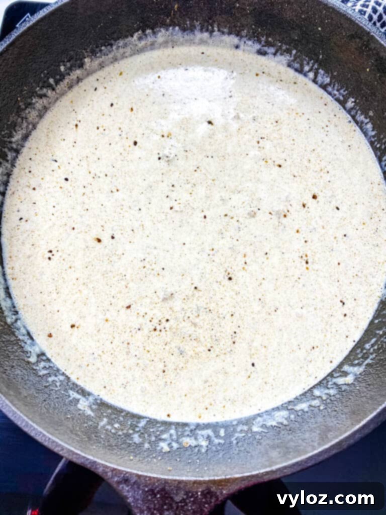 Southern Keto Chicken Fried Steak and Gravy 9 country gravy in a cast iron skillet