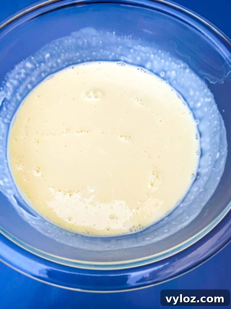 Effortless Keto Crème Brûlée 5 Keto low-carb crème brûlée custard mixture in a glass bowl, ready to be poured into ramekins for baking