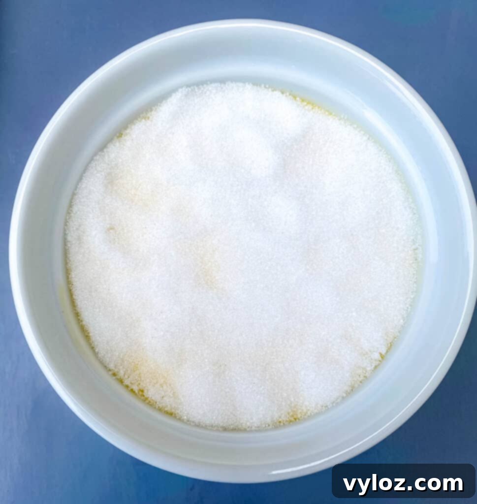 Effortless Keto Crème Brûlée 9 Keto low-carb crème brûlée in a white ramekin with sweetener evenly sprinkled on top, ready for torching