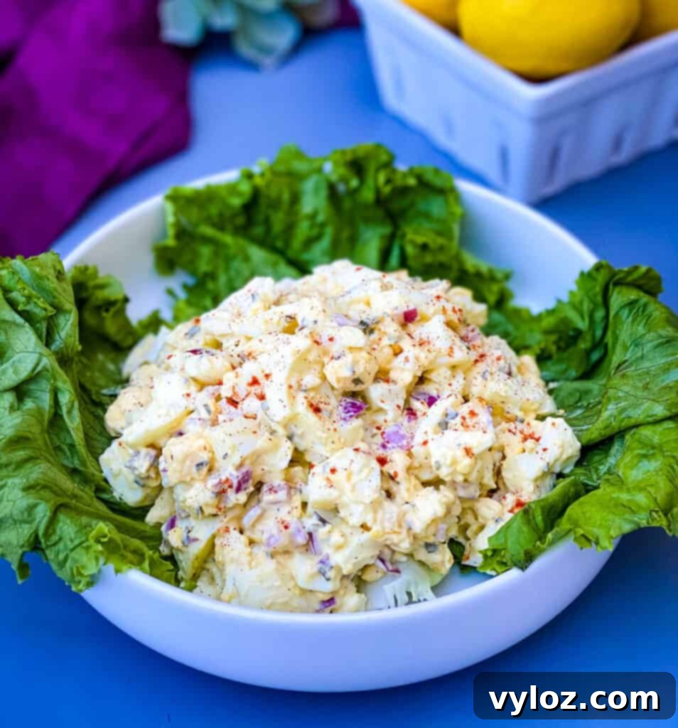 Vibrant Egg Salad 2 keto low carb egg salad on a bed of lettuce in a white bowl