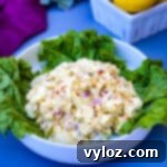 Vibrant Egg Salad 11 keto low carb egg salad on a bed of lettuce in a white bowl