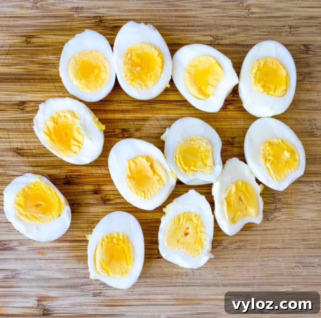 Vibrant Egg Salad 4 hard boiled eggs sliced in half on a cutting board