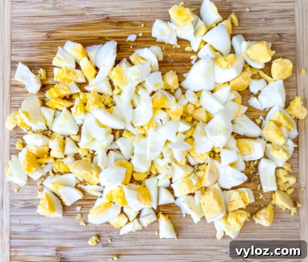 Vibrant Egg Salad 5 chopped hard boiled eggs on a cutting board