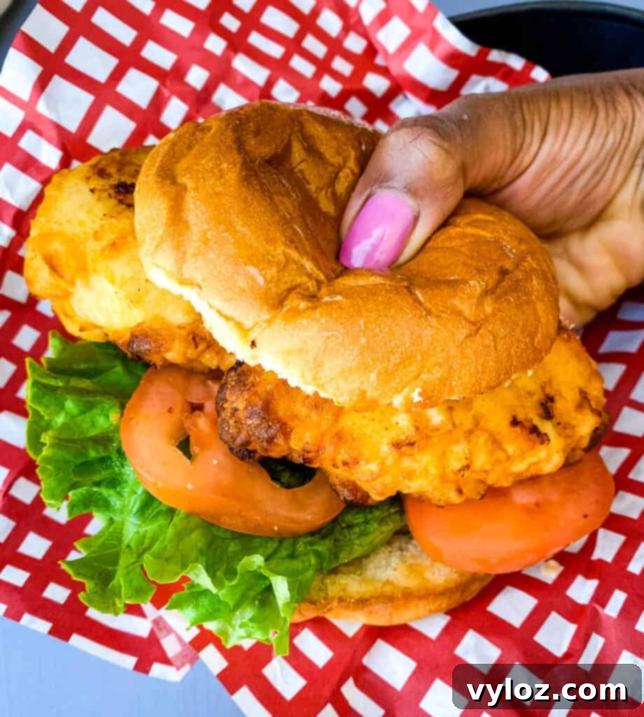 person holding chick-fil-a chicken sandwich
