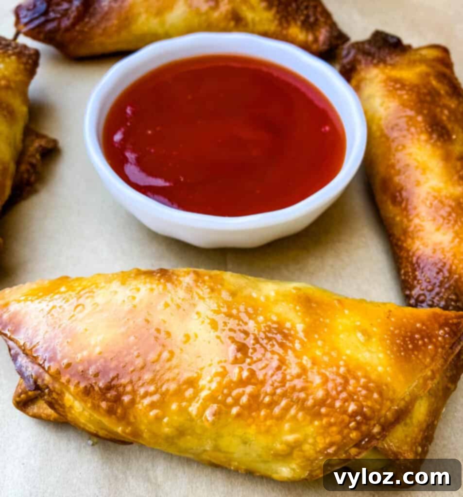 Crispy homemade shrimp egg rolls generously coated in sweet and sour sauce, presented on a rustic flat surface, ready to be enjoyed.