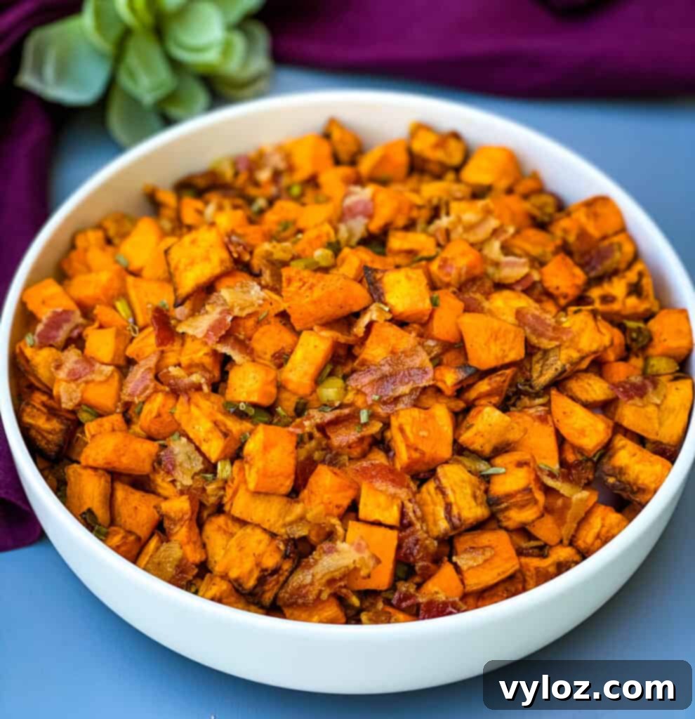 Crispy Air Fryer Sweet Potato Hash 2 Air fryer sweet potato hash with chopped bacon in a white bowl, ready to serve.