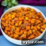 Crispy Air Fryer Sweet Potato Hash 12 Air fryer sweet potato hash with chopped bacon in a white bowl.