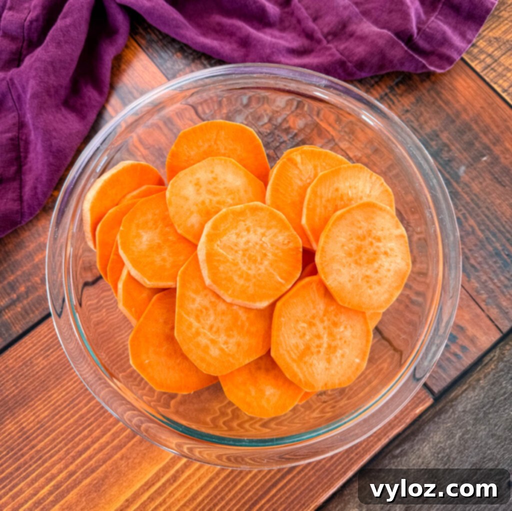 Mama's Easy Candied Sweet Potatoes 3 peeled and sliced sweet potato rounds in a glass bowl