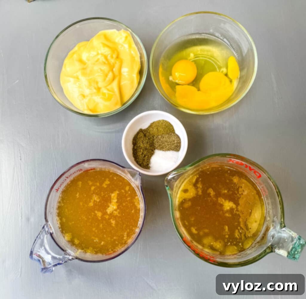 A vibrant selection of ingredients for Southern cornbread dressing, including creamy chicken soup, fresh raw eggs, rich chicken broth, aromatic sage, and robust poultry seasoning, all neatly arranged in separate bowls.